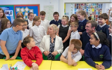 Lia Nici MP (Centre) surrounded by pupils