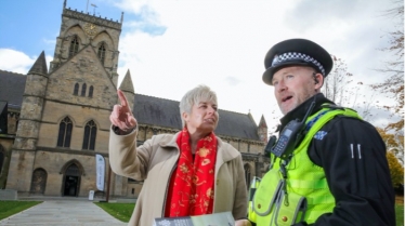 Lia Nici MP (Left) talking to C.I. Dave Stephenson (Right), standing in front of a church.